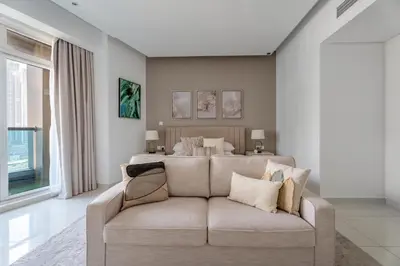 a living room with a couch and a bed at GuestReady - Canal View Studio | Near Dubai Mall in Dubai
