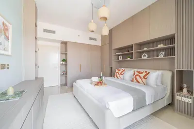 a bedroom with a large white bed and shelves at Frank Porter - Rahaal 2 in Dubai