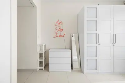 a white room with a door and a mirror at Stunning 2BR in Downtown Partial Burj Khalifa View in Dubai