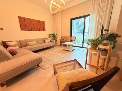 a living room with a couch and a table at 2bed Canalside Home - Marina in Dubai