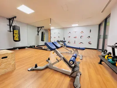 a gym with treadmills and exercise bikes in a room at 2bed Canalside Home - Marina in Dubai