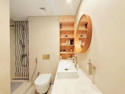a bathroom with two sinks and a toilet and a mirror at 2bed Canalside Home - Marina in Dubai