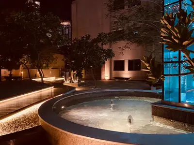 a swimming pool in the middle of a building at night at 2bed Canalside Home - Marina in Dubai