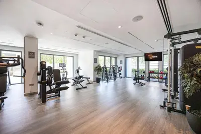 a gym with several treadmills and exercise equipment at New LUX 1 BDR apartment in Downtown Dubai in Dubai