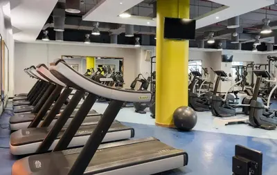 a gym with rows of treadmills and machines at FIRST CLASS 2BR Vibrant Retreat Near JBR Beach in Dubai