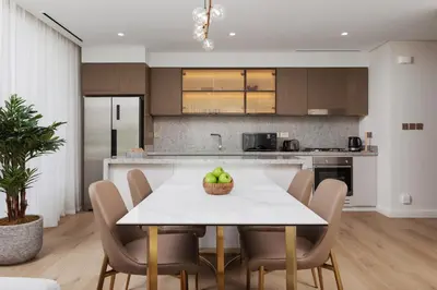 a kitchen and dining room with a table and chairs at Elegant 2BR Apartment with Sea View in Dubai