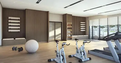 a gym with treadmills and exercise bikes in a room at Elegant 2BR Apartment with Sea View in Dubai