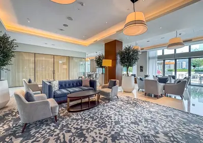 a living room with a blue couch and chairs at Ultra-Luxury Burj & Fountain Suite at Address Opera in Dubai