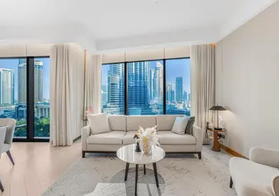 a living room with a couch and a table at Ultra-Luxury Burj & Fountain Suite at Address Opera in Dubai