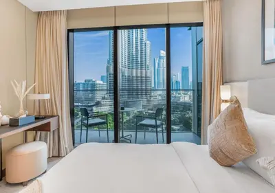 a hotel room with a bed and a large window at Ultra-Luxury Burj & Fountain Suite at Address Opera in Dubai