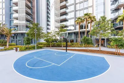 a basketball court in front of a building at 3BR Luxury Stay with Maid Room and Views of Ain Dubai & Sea in Dubai