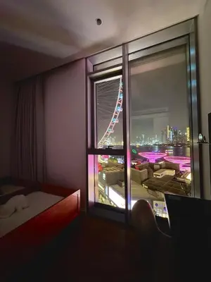 a room with a window with a view of a city at 3BR Luxury Stay with Maid Room and Views of Ain Dubai & Sea in Dubai