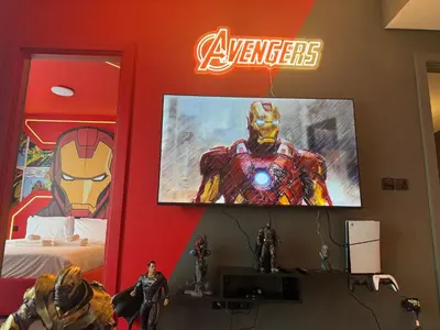 a room with a tv and a superhero on the wall at Capsule Super Heroes - Playstation 5 Burj Khalifa View - Near Downtown Dubai in Dubai