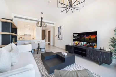 a living room with a couch and a tv at New Luxury Canalfront 2 Bedroom Apartment with Burj Views in Dubai