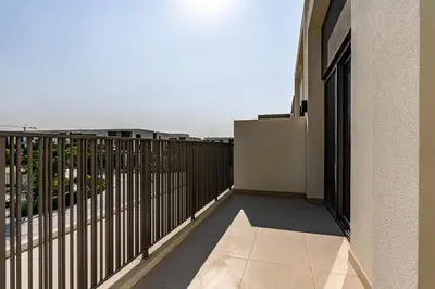a balcony with a view of a city at Modern Townhouse in Tilal Al Ghaf I Aura Gardens in Dubai