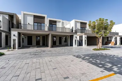 an empty parking lot in front of a building at Modern Townhouse in Tilal Al Ghaf I Aura Gardens in Dubai