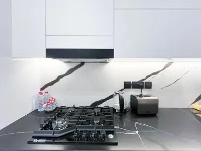 a kitchen counter with a stove top and a tv at Luxury Studio Business Bay Near Dubai Mall in Dubai