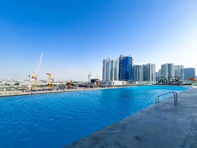 a large swimming pool with a city in the background at Luxury Studio Business Bay Near Dubai Mall in Dubai
