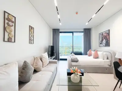 a living room with a couch and a bed at Luxury Studio Business Bay Near Dubai Mall in Dubai