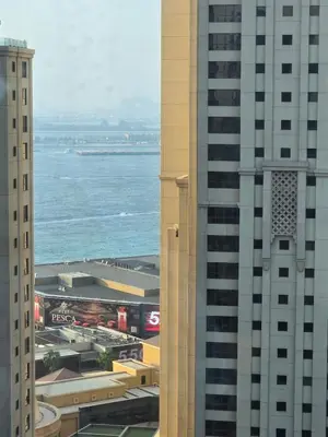 a view of the ocean between two tall buildings at 1 BR Apartment in Dubai Marina - Paloma Tower - Sea View - 3 Mins away from Tram & Beach in Dubai