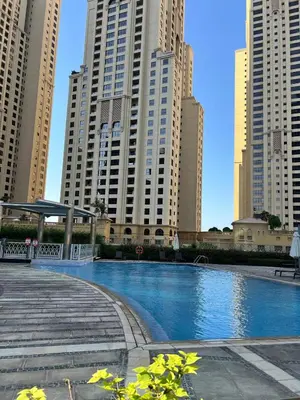 a swimming pool in a city with tall buildings at 1 BR Apartment in Dubai Marina - Paloma Tower - Sea View - 3 Mins away from Tram & Beach in Dubai