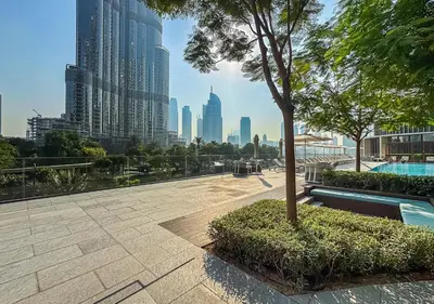 a park with a tree and a view of a city at Burj Khalifa & Fountain Sky Suite on The Address Opera in Dubai