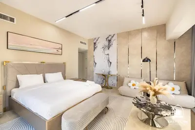 a bedroom with a bed and a couch and a table at Spacious 4BR Stay Sea JBR Views Sadaf 8 EB in Dubai