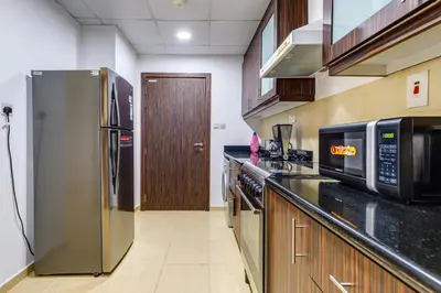 a kitchen with a stainless steel refrigerator and a microwave at Modern 2 BDR Apartment with Sea View Shams 1 JBR in Dubai