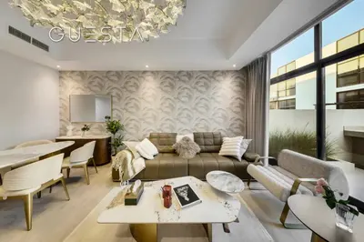 a living room with a couch and a table at Senses at the Fields - Villa with a Private Pool in Dubai
