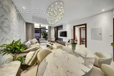 a living room with a marble table and chairs at Senses at the Fields - Villa with a Private Pool in Dubai