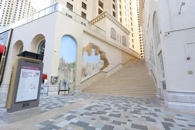 a building with a staircase in the middle of a street at Stylish JBR Studio Beach View EB in Dubai