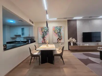 a kitchen and dining room with a table and chairs at Stylish JBR Studio Beach View EB in Dubai
