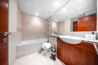 a bathroom with a sink and a toilet and a tub at Surrounded by Nature Near Internet & Media City in Dubai