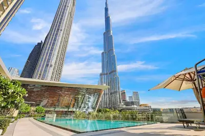 a view of the shard from the rooftop of a hotel with a swimming pool at Vogue Downtown Grande Signature Residences, near Dubai Mall and Burj Khalifa, Two-Bedroom Apartment with Large Balcony, Infinity Pool with Burj Khalifa View, Access to all Amenities in Dubai