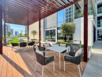 a patio with a white table and chairs at Azizi Riviera 63 in Dubai