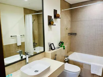 a bathroom with a sink and a tub and a toilet at Skyline 22 1 Residence in Dubai