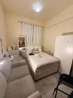 a living room with a bed and a couch at ShortStayDubai in Dubai