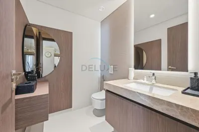 a bathroom with a sink and a toilet at Balcony with Majestic Sea and Palm View with Assistant Room, Private Beach Access, Minutes from Marina and Palm Jumeirah Destinations, Emaar Beachfront by Deluxe Holiday Homes in Dubai