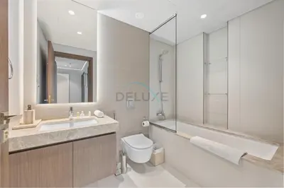 a bathroom with a sink and a toilet and a tub at Balcony with Majestic Sea and Palm View with Assistant Room, Private Beach Access, Minutes from Marina and Palm Jumeirah Destinations, Emaar Beachfront by Deluxe Holiday Homes in Dubai