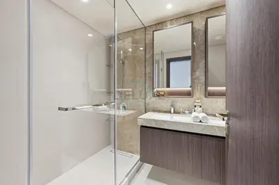 a bathroom with a sink and a glass shower at Balcony with Majestic Sea and Palm View with Assistant Room, Private Beach Access, Minutes from Marina and Palm Jumeirah Destinations, Emaar Beachfront by Deluxe Holiday Homes in Dubai