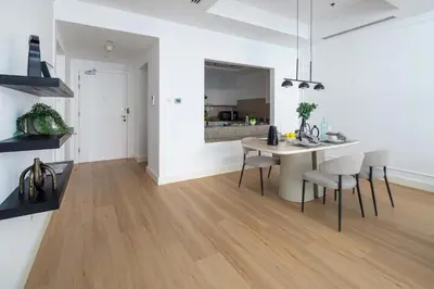 a kitchen and living room with a table and chairs at Frank Porter - Bay Square 1 in Dubai