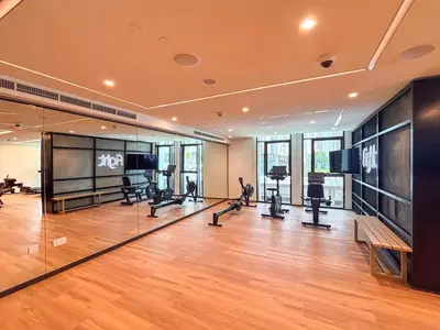 a gym with treadmills and cardio equipment in a building at Frank Porter - Creek Crescent Tower in Dubai
