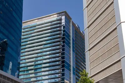 a tall building with many windows in a city at Frank Porter - Merano Tower in Dubai