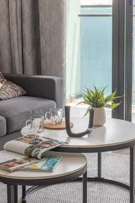 a coffee table in a living room with a couch at Frank Porter - Merano Tower in Dubai