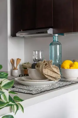 a table with plates and bowls of lemons on it at Frank Porter - Merano Tower in Dubai