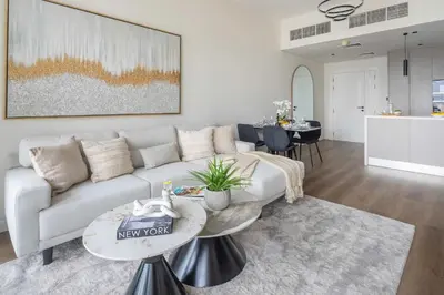a living room with a couch and a table at Frank Porter - Silverene Towers A in Dubai