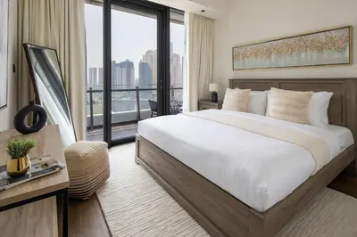 a bedroom with a large bed and a large window at Frank Porter - Silverene Towers A in Dubai