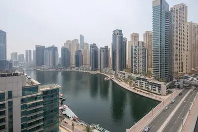 a river in a city with tall buildings at Frank Porter - Silverene Towers A in Dubai