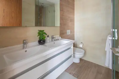a bathroom with a white sink and a toilet at Frank Porter - No, 9 Dubai Marina in Dubai
