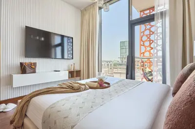a hotel room with a bed and a large window at Frank Porter - National Bonds Residence in Dubai